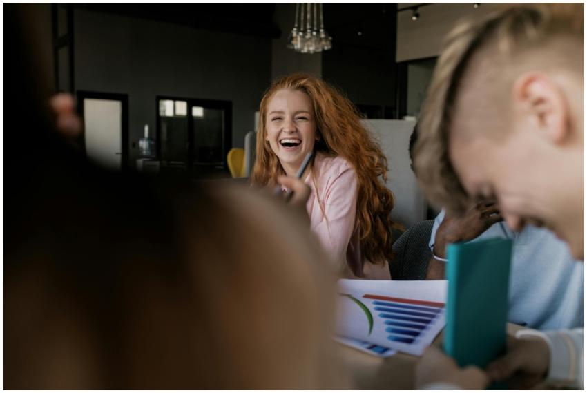 Joyful red-haired woman laughing during a casual m