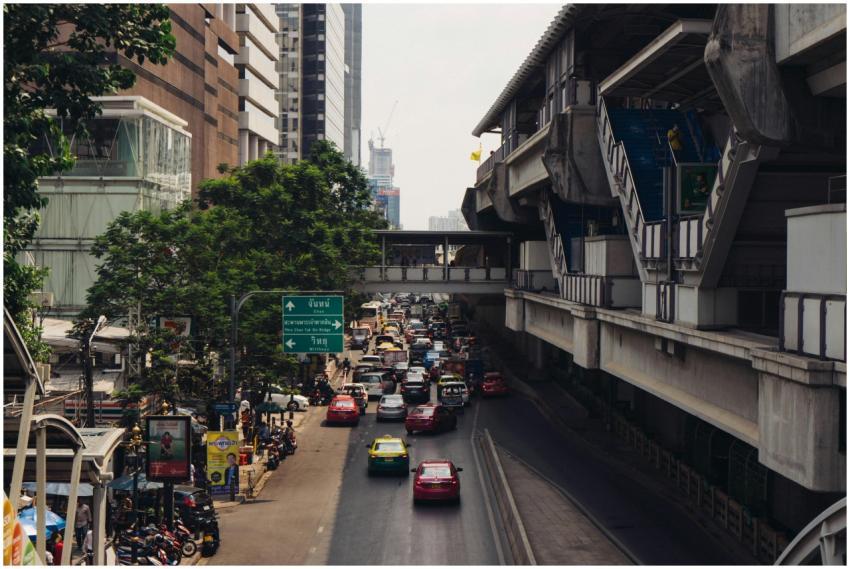 A bustling street in downtown Bangkok with traffic