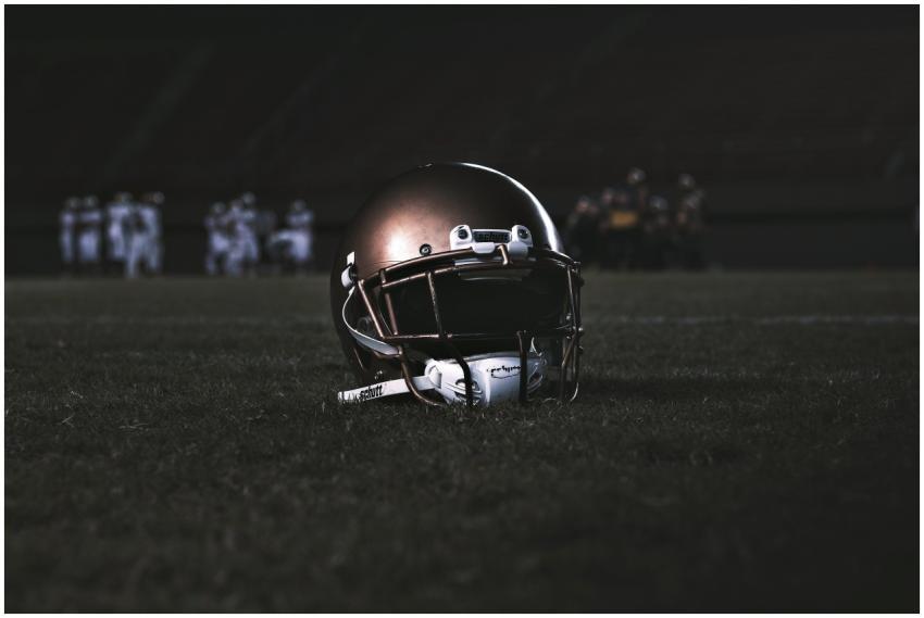 A football helmet placed on a grassy field during