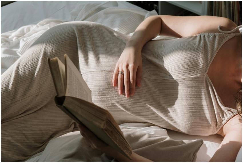 Pregnant woman with flowing dress reading a book i