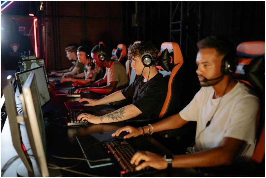 A group of focused young gamers playing in an inte
