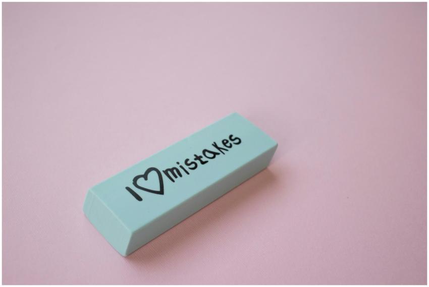 Close-up of a mint green eraser with 'I love mista