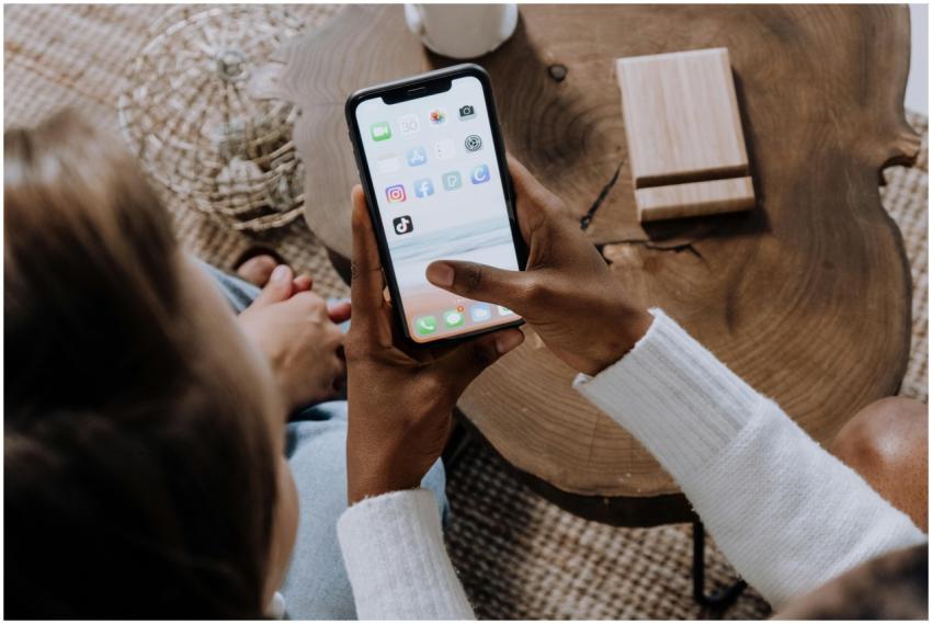 A person using a smartphone with social media apps