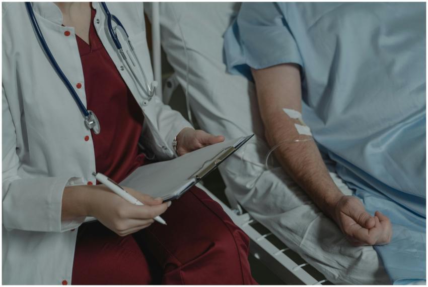 Doctor reviewing medical chart while assisting a p