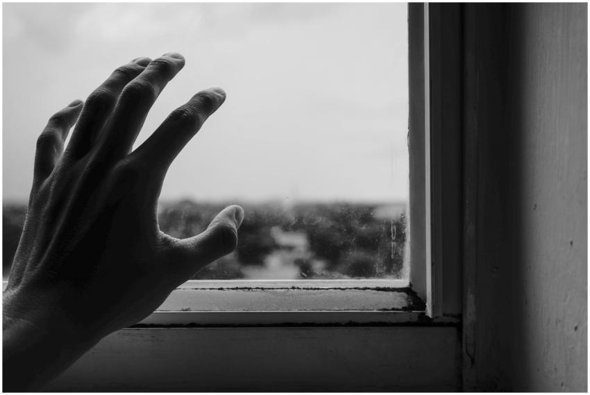 Abstract monochrome photo of a hand reaching towar