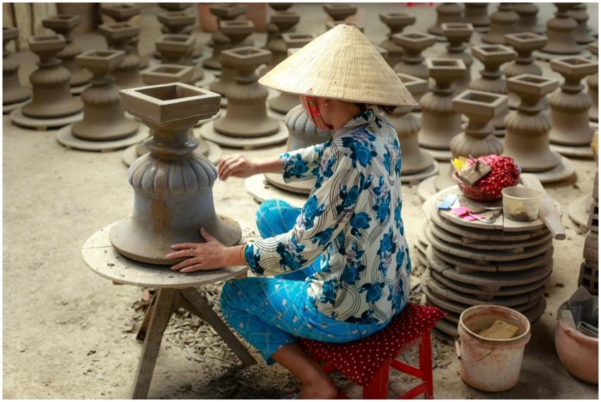 Artisan in traditional attire crafting earthenware