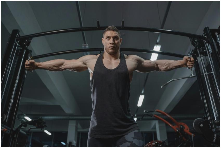 A strong man in activewear working out on a cable