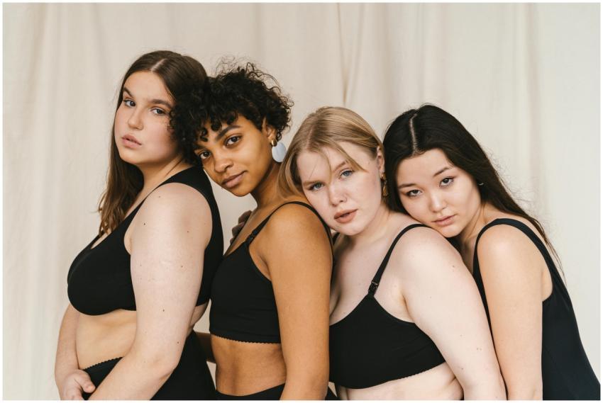 Portrait of a diverse group of women embracing bod