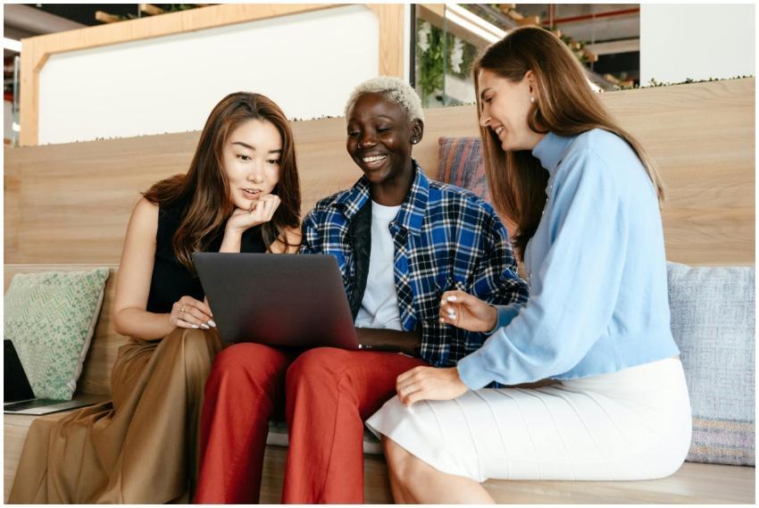 Group of happy trendy multiethnic women surfing in