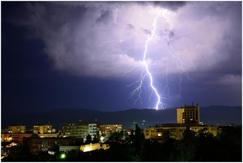 Dynamic night scene showcasing a powerful lightnin