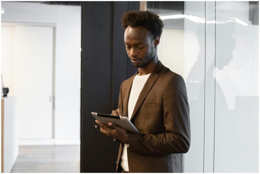 A professional man in business attire using a tabl