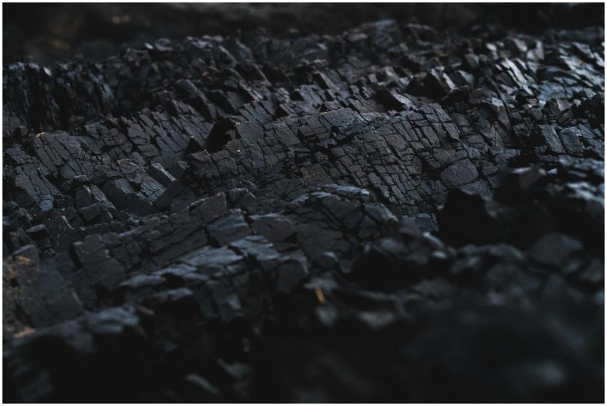 A detailed close-up of dark charcoal texture, show
