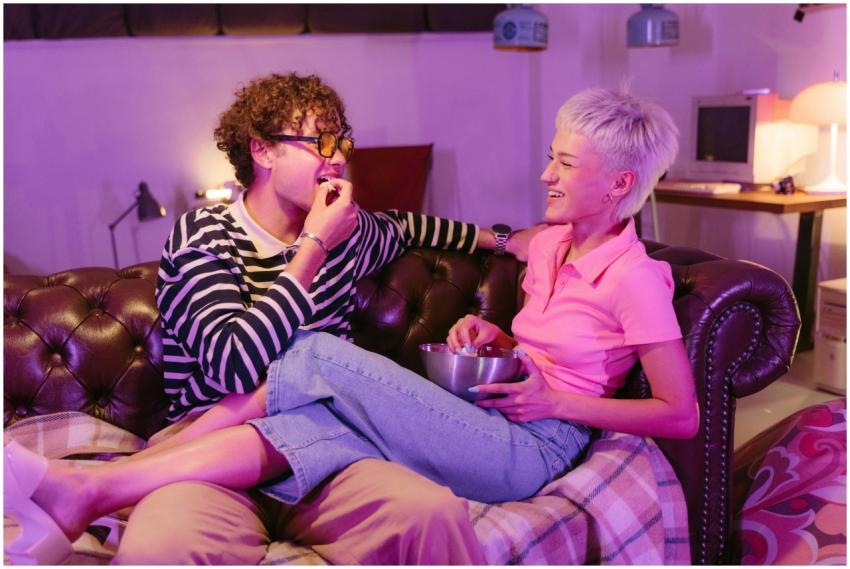 Friends enjoying a night in with popcorn and laugh
