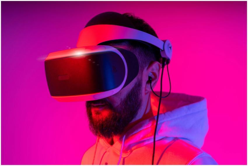 A man wearing a VR headset is immersed in virtual
