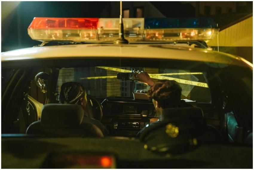 Police officers monitoring a scene through rearvie