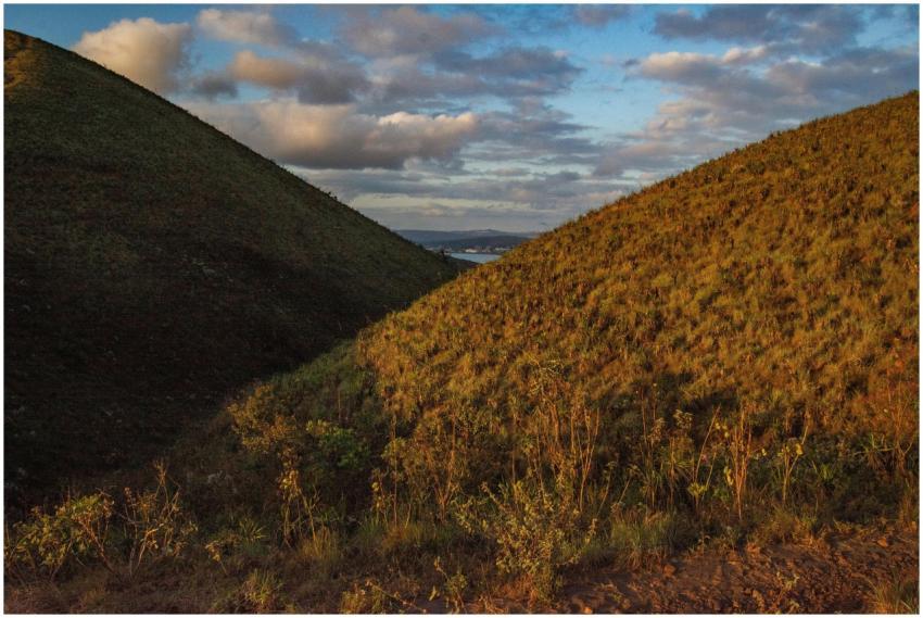Sunset over lush hills in Minas Gerais creates a s
