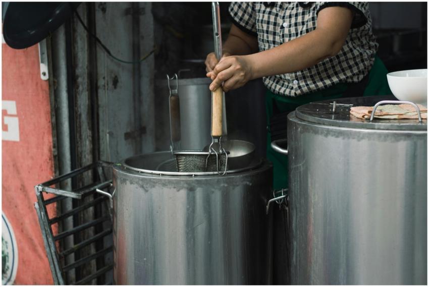 Street vendor preparing traditional Vietnamese noo