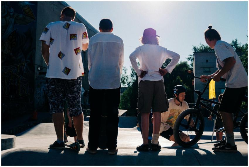 Teenagers enjoying BMX and skateboarding at an urb