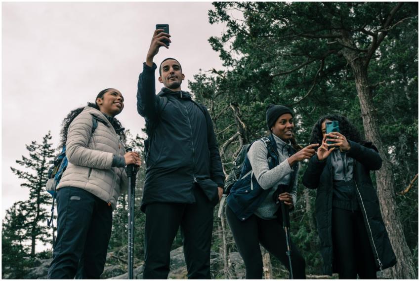 Four friends enjoying a hike, capturing the moment