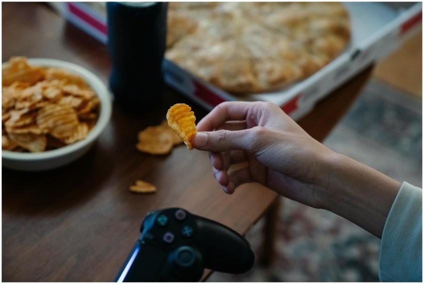 A person holding a chip while playing a video game
