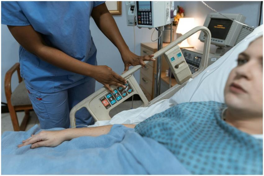 A nurse in scrubs assists a patient in a hospital