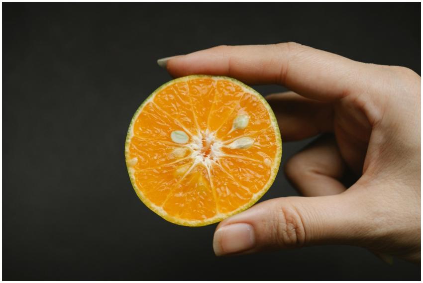 Crop anonymous female demonstrating fresh juicy fr