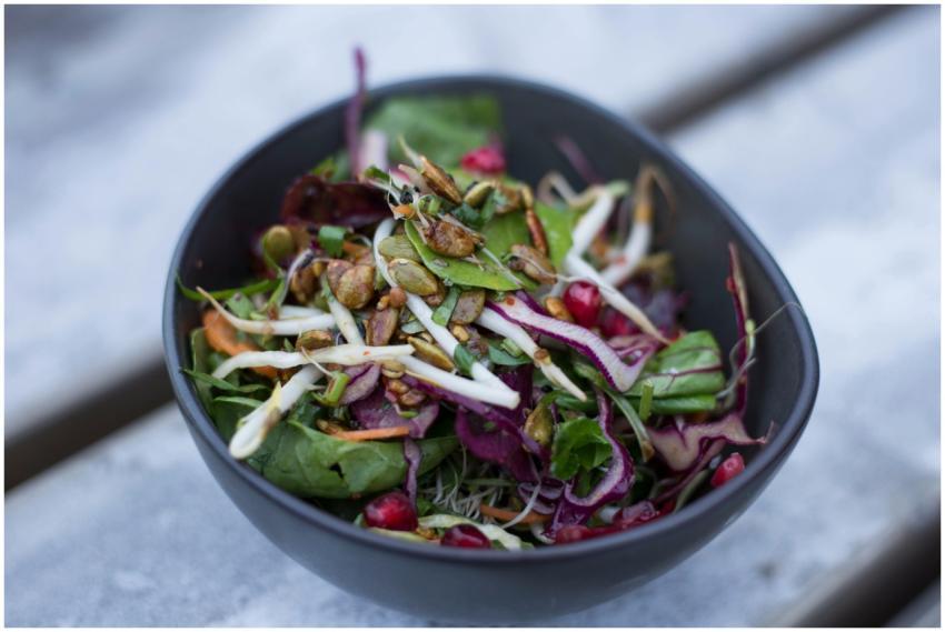 Vibrant salad with mixed greens, nuts, and pomegra