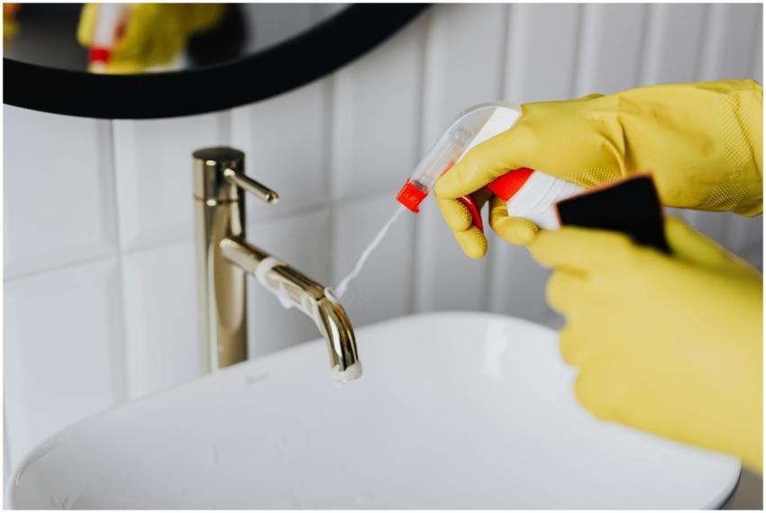 From above anonymous housekeeper in yellow rubber