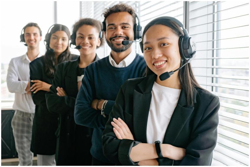 A diverse group of smiling call center agents in a