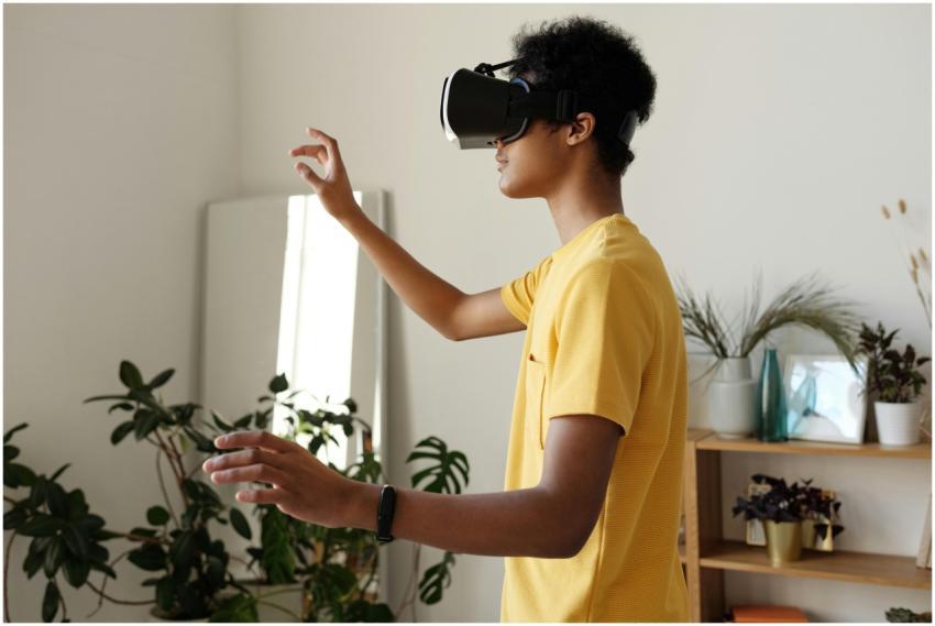 Teen enjoying virtual reality with VR headset at h