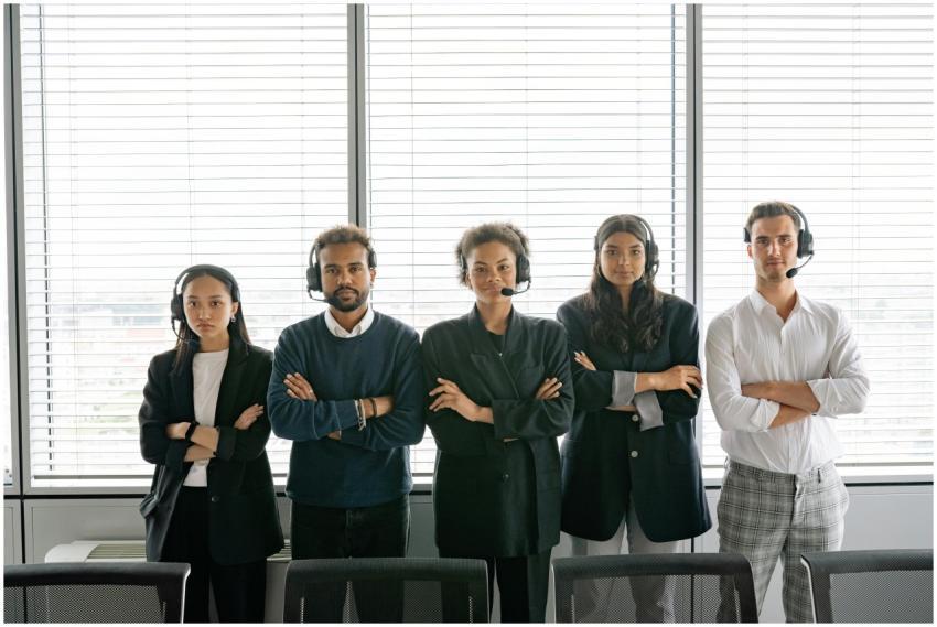 A diverse group of call center agents standing wit