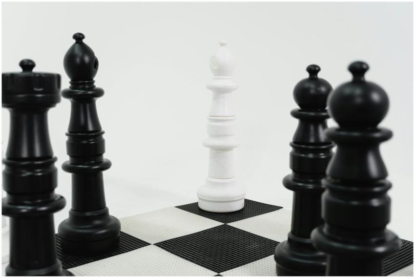 Close-up of chess pieces in strategic formation on