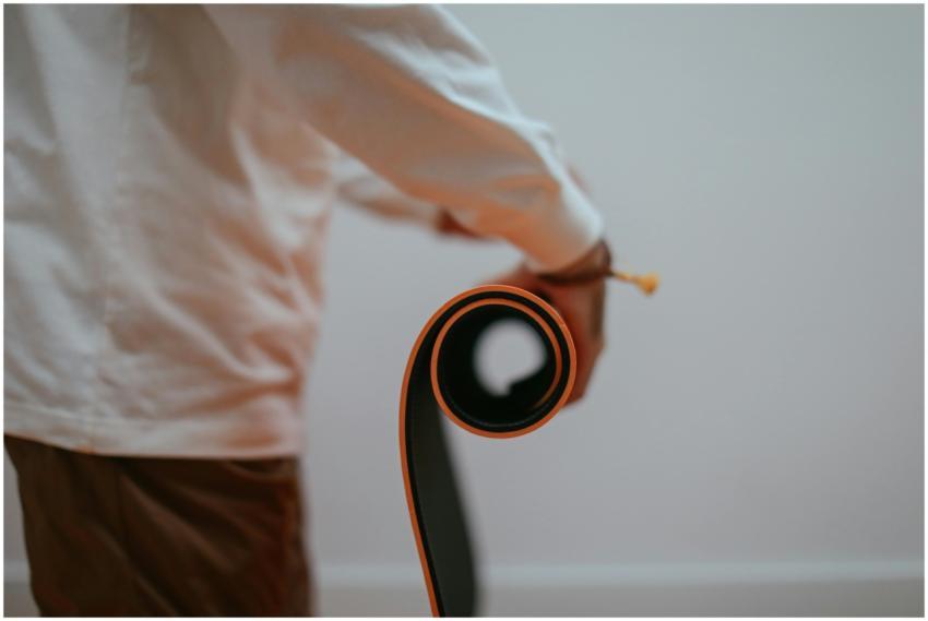 Close-up of a person rolling a yoga mat indoors, h