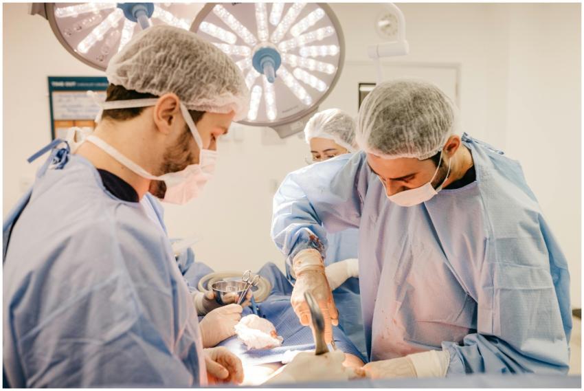 Team of surgeons working diligently in a well-lit
