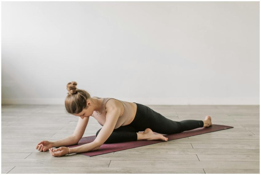 Woman in yoga pose on mat, promoting fitness and w