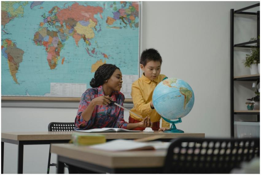Teacher and student engaging with a globe in a cla