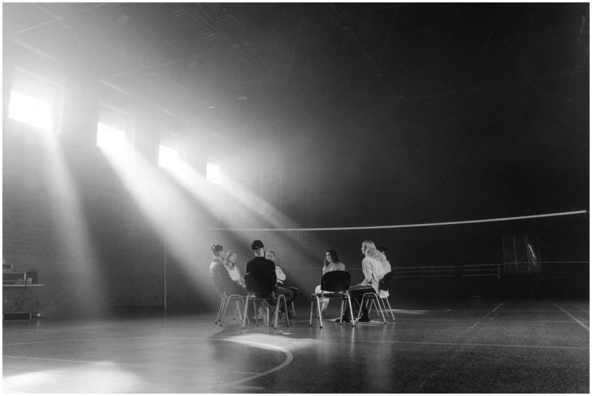 A group of people having a discussion in a sunlit