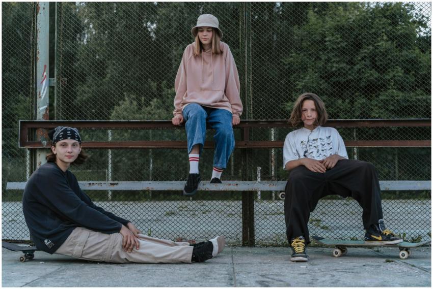 Group of teenagers hanging out together with skate