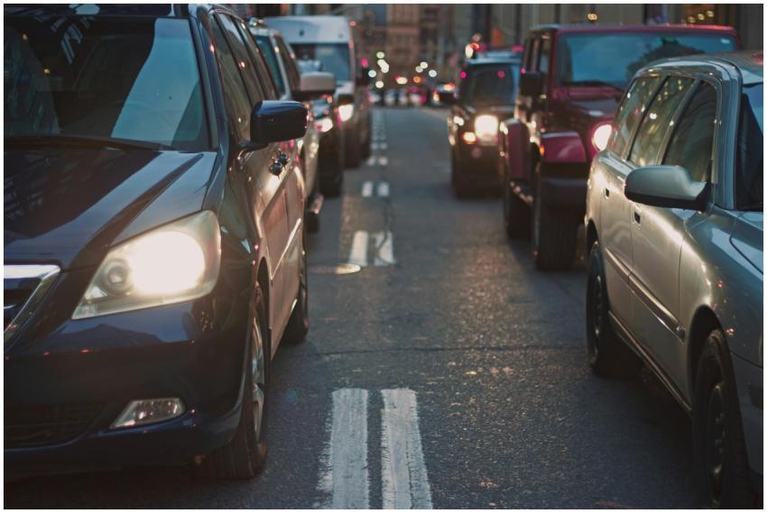 A congested city street lined with cars stuck in t