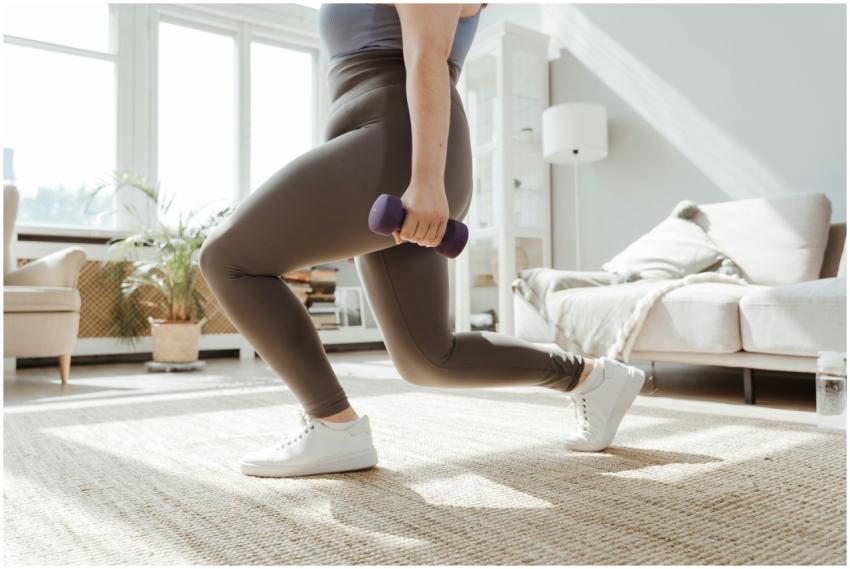 A woman in active wear performs a lunges exercise