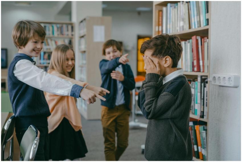 Group of children bullying a classmate in a school