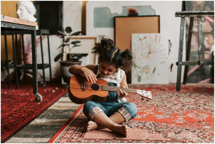 Adorable young girl sitting on the floor playing a