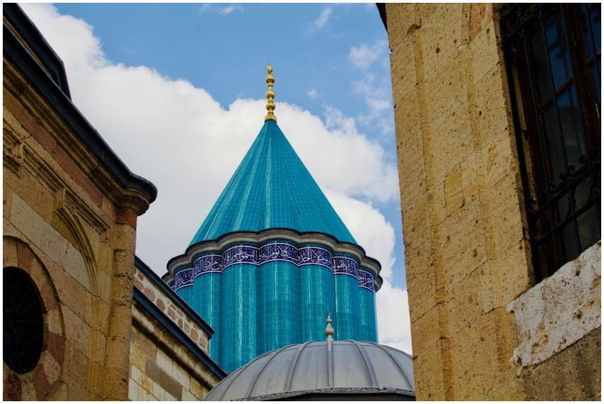 The iconic blue-tiled dome of Mevlana Museum captu