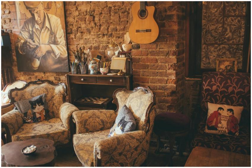 Warm vintage room with armchairs, guitar, and artw