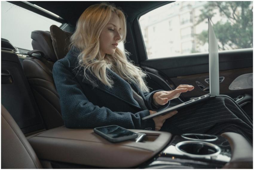 Businesswoman working on a laptop inside a luxurio