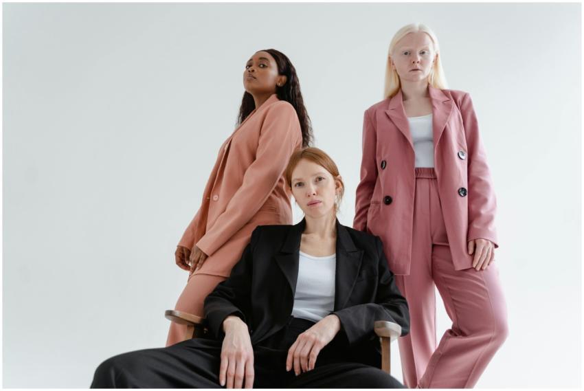 Three diverse women posing confidently in stylish