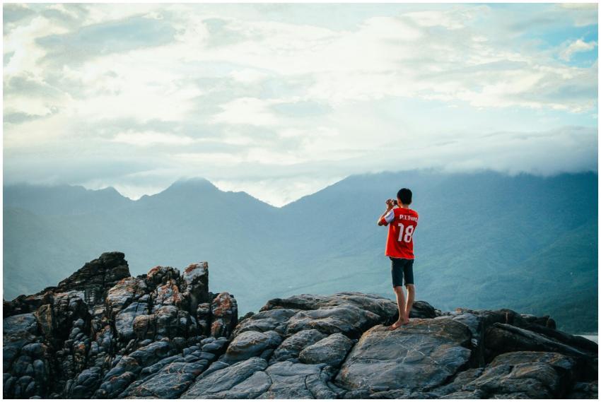 A person enjoying a scenic view on a rocky mountai
