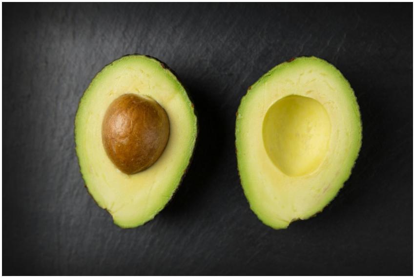 Close-up of fresh sliced avocado halves on a dark