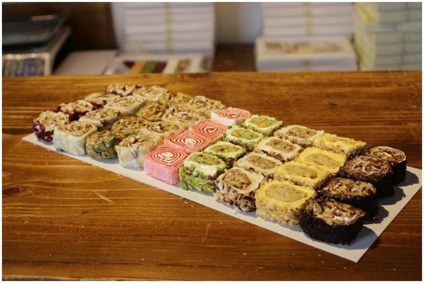 A selection of colorful Turkish desserts on displa