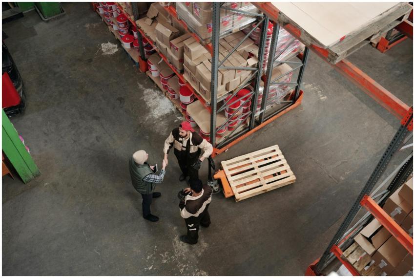 High angle view of workers discussing logistics in